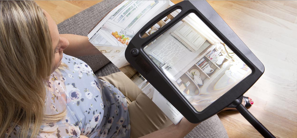 customer reading with magnifying daylight floor lamp